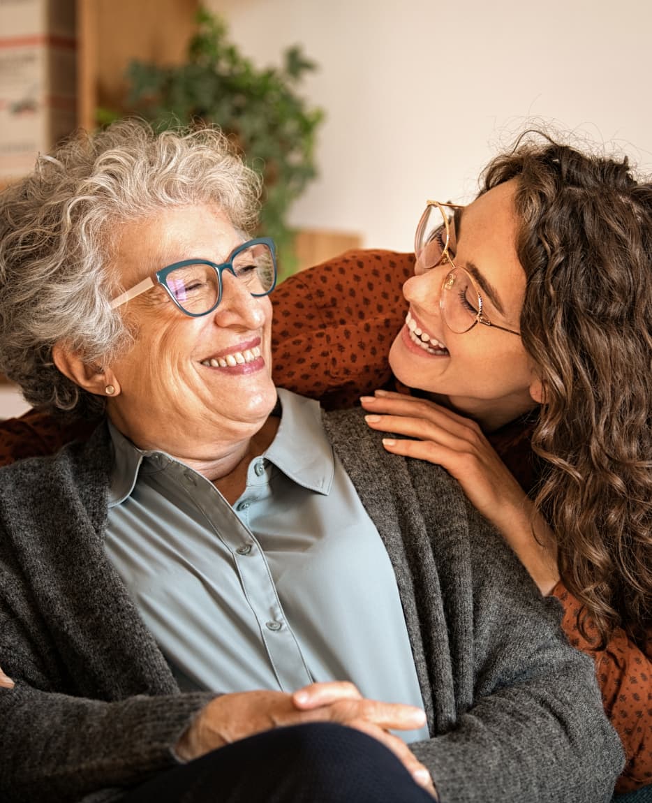 grandmother-and-granddaughter-laughing-and-embraci-2023-11-27-05-27-07-utc